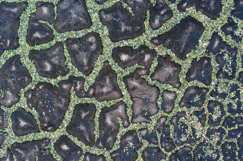Cracked waterproofing and pebbles on cracks