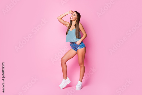 Full length body size view of nice attractive lovely lovable charming pretty well-groomed fashionable gorgeous cheerful cheery brown-haired girl posing isolated over pink pastel color background