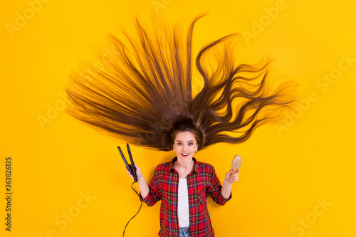 Top view above high angle flat lay flatlay lie concept of her she nice cheerful long-haired girl using modern ceramic iron comb choosing isolated on bright vivid shine vibrant yellow color background