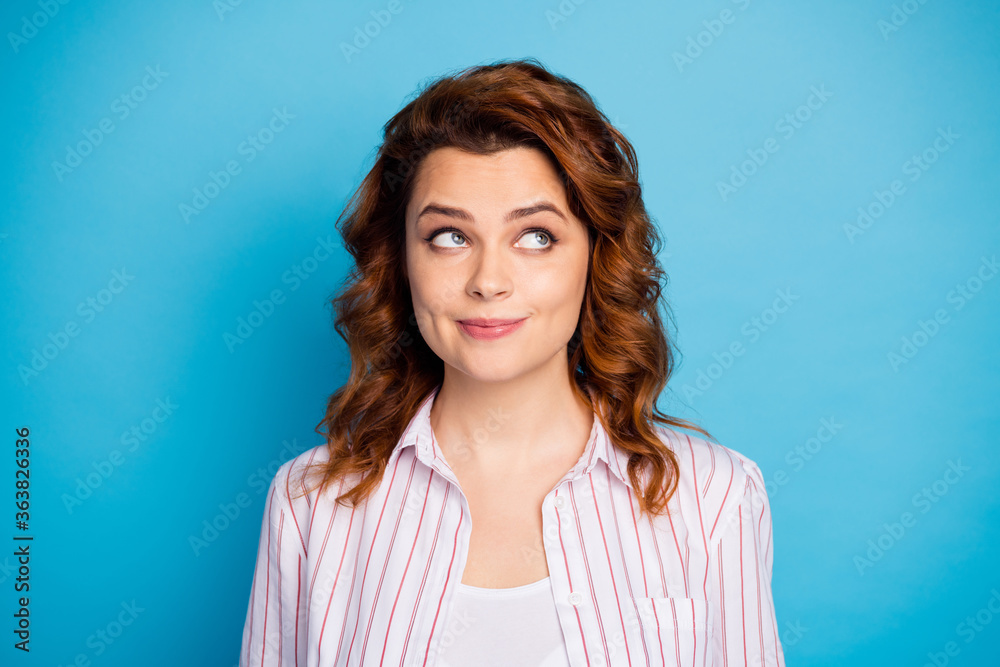 Closeup photo of pretty charming wavy lady dreamer look side up empty space intelligent creative person wear white striped shirt isolated bright blue color background Closeup photo of pretty charming wavy lady dreamer look side up empty space intelligent creative person wear white striped shirt isolated bright blue color background