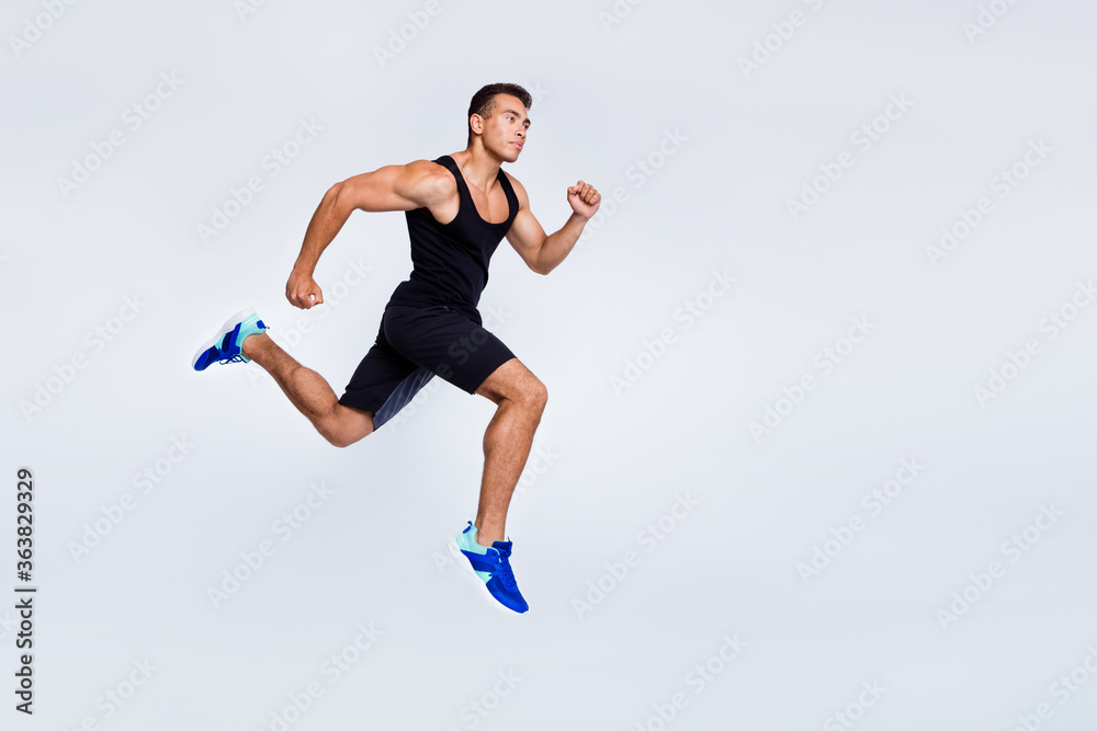 Full length body size view of his he nice attractive muscular sportive strong purposeful guy jumping running jogging distance isolated over light gray pastel color background