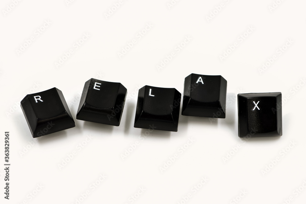Word laid out from the keyboard keys on a white background. Relax word written with computer buttons over white background. Word laid out from the keyboard keys on a white background. Relax word written with computer buttons over white background.
