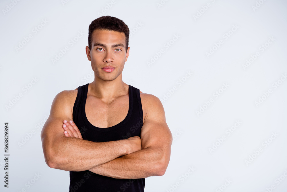 Close-up portrait of his he nice attractive content sportive virile brutal muscular guy champion goal folded arms isolated over gray pastel color background Close-up portrait of his he nice attractive content sportive virile brutal muscular guy champion goal folded arms isolated over gray pastel color background