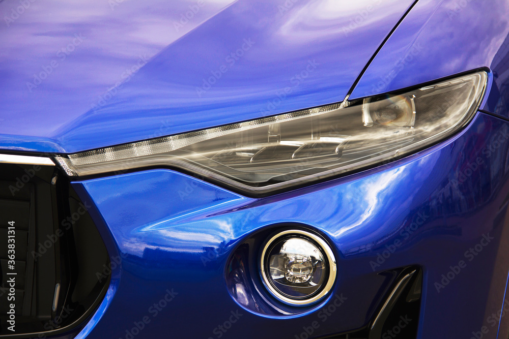 Car headlights. Luxury Headlights. Part of a blue car.