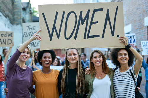 Happy united women protesting for their rights on street demonstrations.