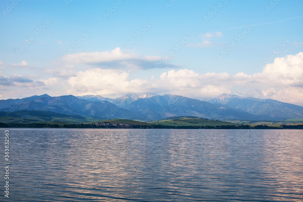 View of a beautiful lake with snowy Tatras in the background