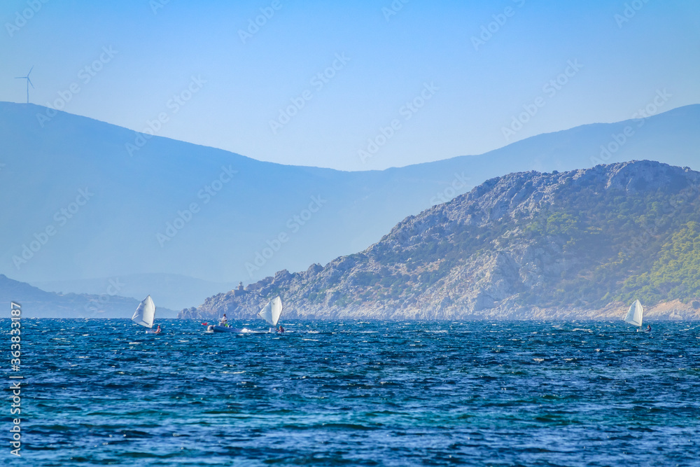 Coach on a Motor Boat and Three Small Sports Yachts in Training