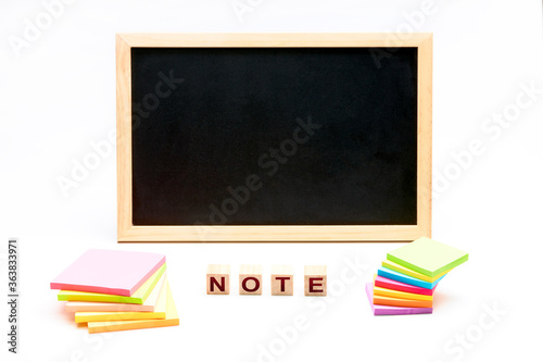 Note next to a blackboard and a bunch of posts