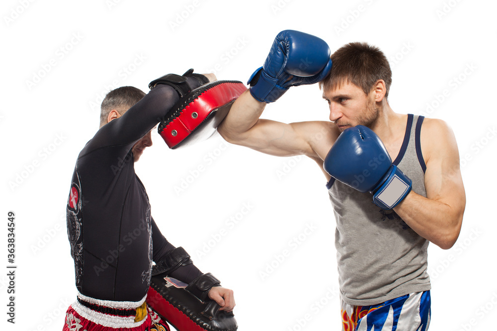 Two caucasian men exercising thai boxing in  studio on white background