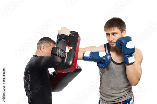 Two caucasian men exercising thai boxing in studio on white background