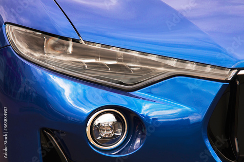 Car headlights. Luxury Headlights. Part of a blue car. © Stasiuk