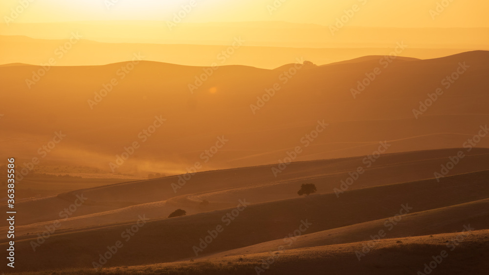 Sunrise or sunset. Inspirational sky background. Calming and relaxing colors and soft light on hills. Sunset landscape in National Park Uzbekistan.