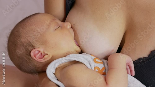 Woman breastfeeding newborn baby. Mother breastfeeding newborn girl. Concept breast feeding. Baby eating mother.