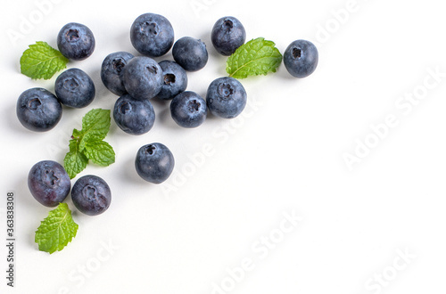 Blueberry fruit top view isolated on a white background, flat lay overhead layout with mint leaf, healthy design concept. © RomixImage