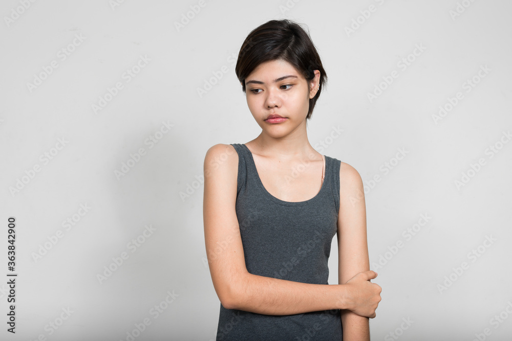 Portrait of stressed young teenage girl thinking and looking down Portrait of stressed young teenage girl thinking and looking down