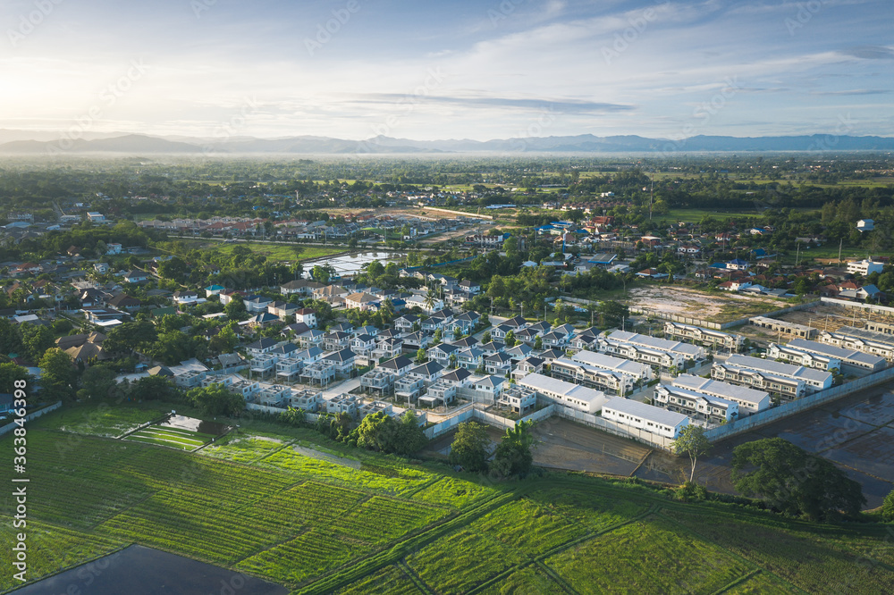 Aerial view of rice field and housing estate in Chiang Mai province of Thailand.