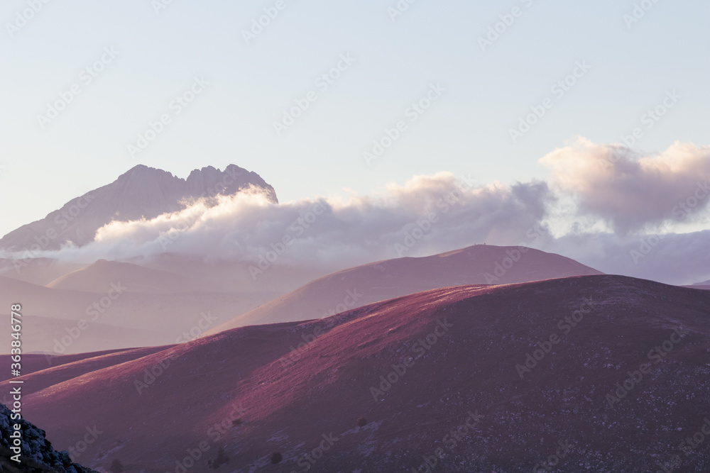 Filtered image. Mountain landscape at sunset with foggy clouds and golden light. Peaceful background and relax landscape. Banner, wallpaper images, backdrop and background with mountain peaceful light