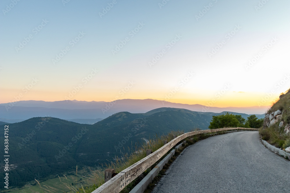 Road at sunset time with mountain view as lansdscape. Winding mountain road
