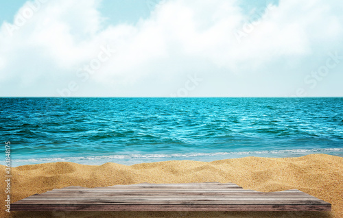 Wooden table top on blue sea and white sand beach background. 