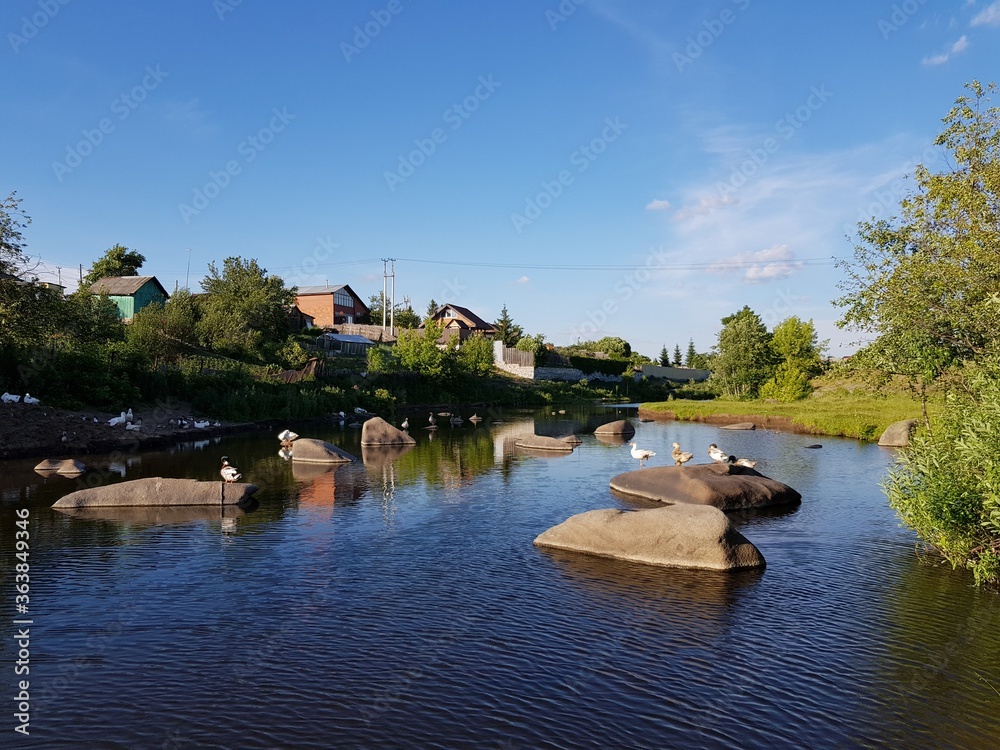 Fototapeta premium Stone boulders lie in the river