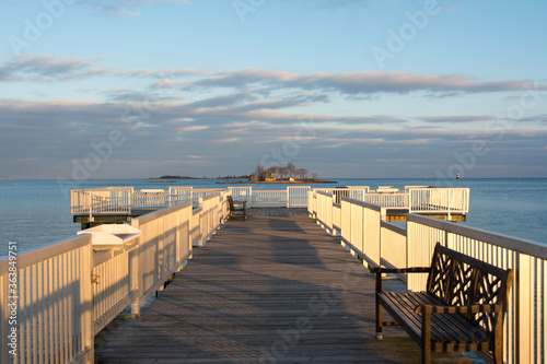 Beautiful golden hour light on the long pier and the Long Island Sound at Calf Pasture Beach in Norwalk, Connecticut USA photo
