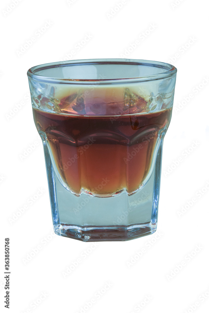 A glass of cognac on a white background is shot very close up A glass of cognac on a white background is shot very close up