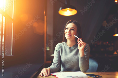 Canvas Print Smiling mindful female journalist working on creation book review planning to sh