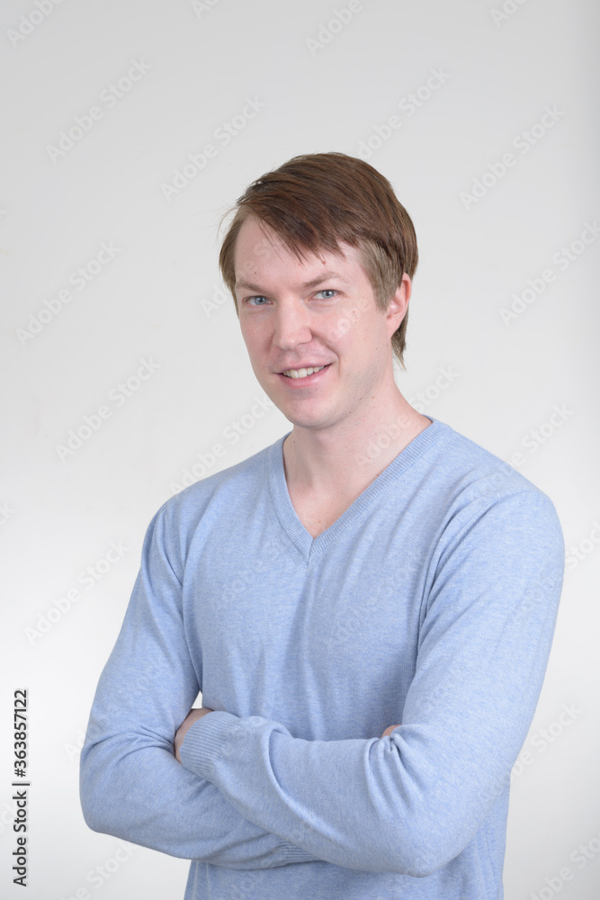 Portrait of happy young handsome man smiling with arms crossed Portrait of happy young handsome man smiling with arms crossed
