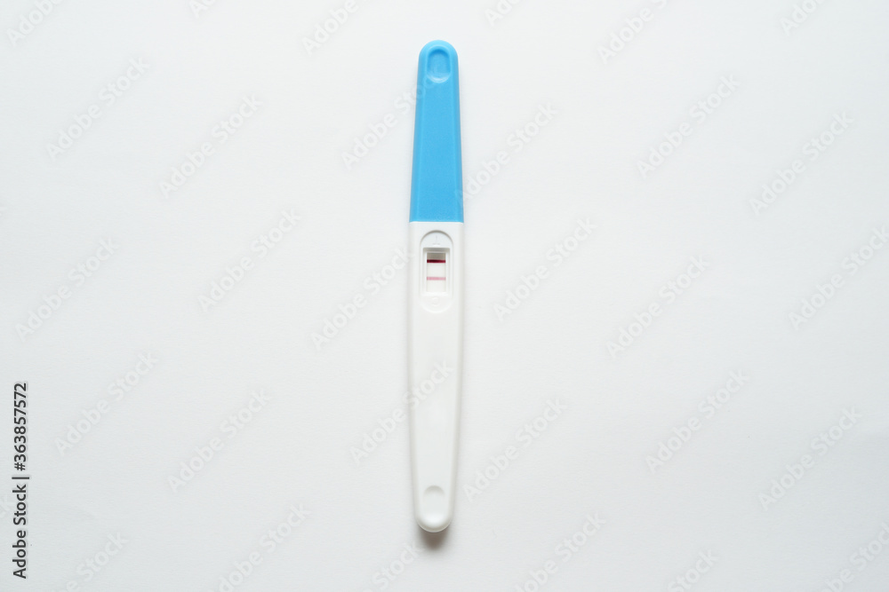 Pregnancy test pack hold by hand on top of white background. Pregnancy test pack hold by hand on top of white background.