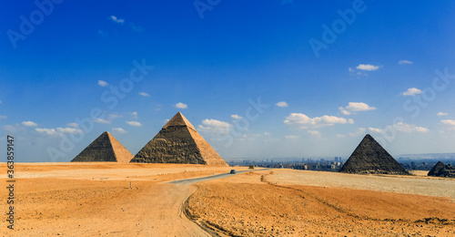 Giza, Cairo / Egypt: Long view of the Pyramids of Giza with Cairo in the distance