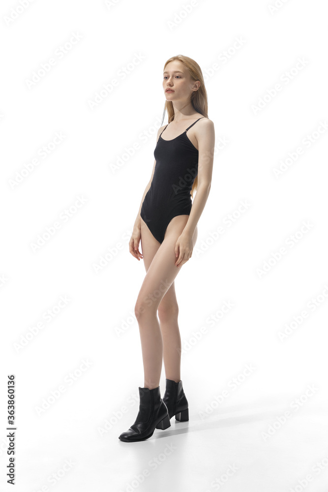 Portrait of beautiful redhead woman isolated on white studio background. Concept of beauty, skin care, fashion and style. Artwork, modern and trendy portrait. Attractive model in black bodysuit. Portrait of beautiful redhead woman isolated on white studio background. Concept of beauty, skin care, fashion and style. Artwork, modern and trendy portrait. Attractive model in black bodysuit.