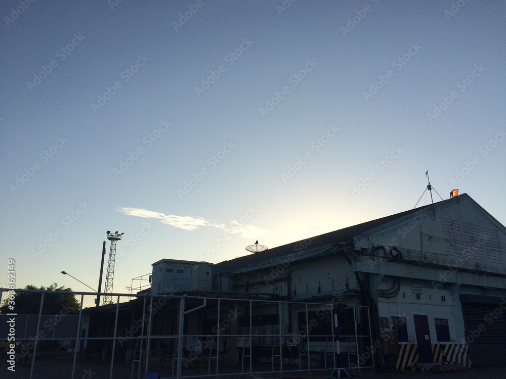 warehouse at port with evening sky 