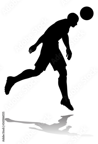 A soccer or football player in silhouette