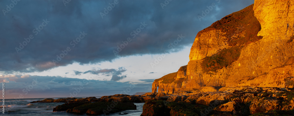 White Rocks cliffs in summer sunset on the Causeway Coast, Northern Ireland