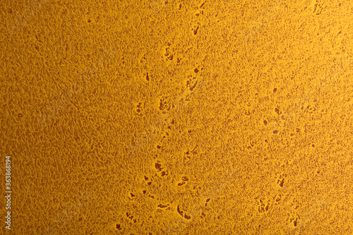 yellow orange background from building plaster applied to a wooden base, macro