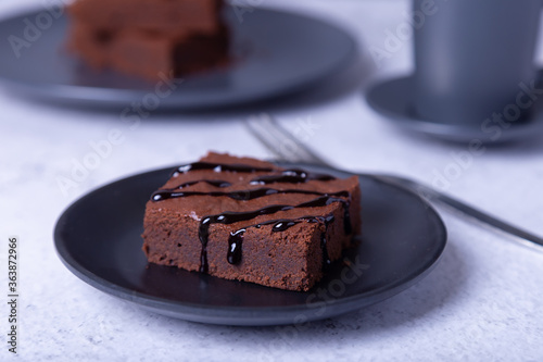 Brownie cake with Chocolate Sauce. Homemade Chocolate Dessert. A popular dark chocolate cake. Close-up.