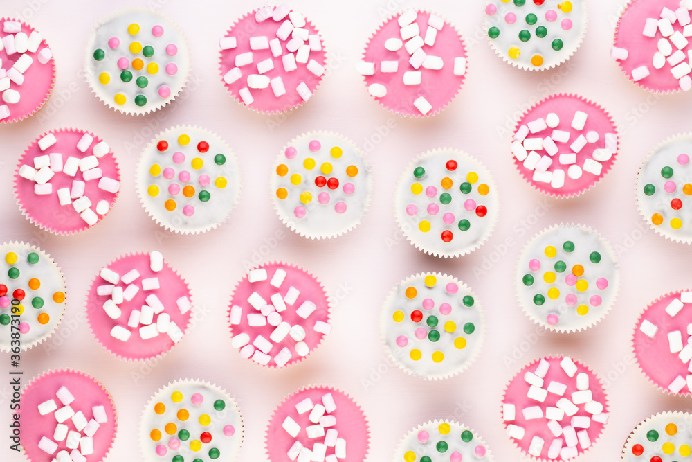 Colorful cupcakes on a white background.