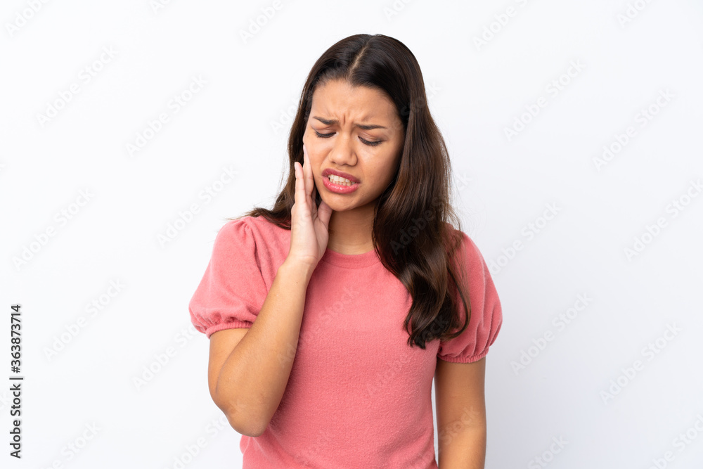 Young Colombian girl over isolated white background with toothache Young Colombian girl over isolated white background with toothache