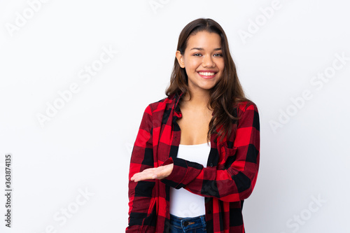 Young Colombian girl over isolated white background extending hands to the side for inviting to come