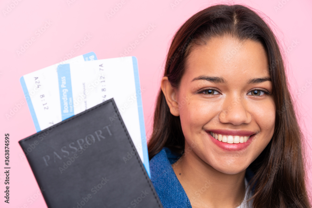 Young Colombian girl with a passport over isolated background Young Colombian girl with a passport over isolated background