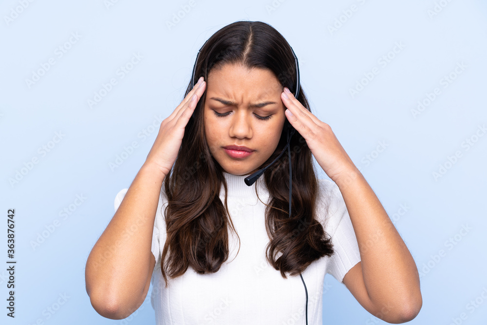 Young telemarketer Colombian woman over isolated blue background unhappy and frustrated with something. Negative facial expression Young telemarketer Colombian woman over isolated blue background unhappy and frustrated with something. Negative facial expression