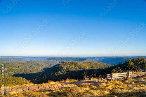 Bench at mountaintop in sunlight  looking far into the distance