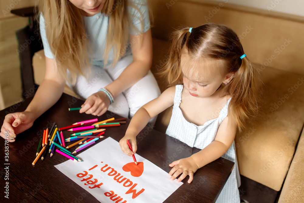 A little girl of 2 years old has drawn a blond mother a gift card with a French text Happy Mother’s Day and congratulates her A little girl of 2 years old has drawn a blond mother a gift card with a French text Happy Mother’s Day and congratulates her