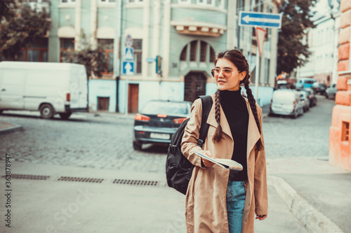 Cute brunette girl on the way to university on her first day abroad.