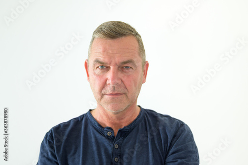 Middle-aged man scrutinising the camera