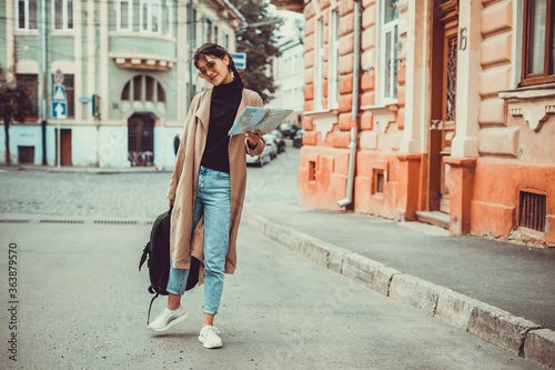 Cute brunette girl on the way to university on her first day abroad.