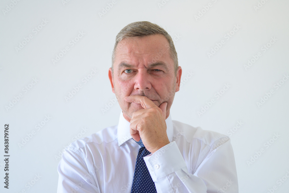Worried anxious businessman with hand to chin Worried anxious businessman with hand to chin