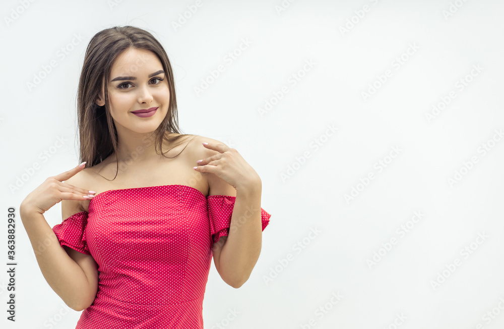Young magnificent woman posing in trendy red dress over white background. Young magnificent woman posing in trendy red dress over white background.