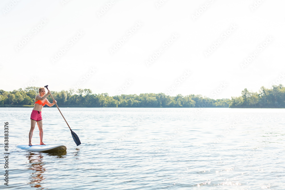 Action Shot of Young Woman on Paddle Board Action Shot of Young Woman on Paddle Board