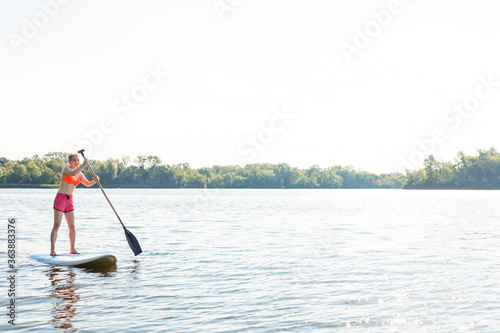 Action Shot of Young Woman on Paddle Board